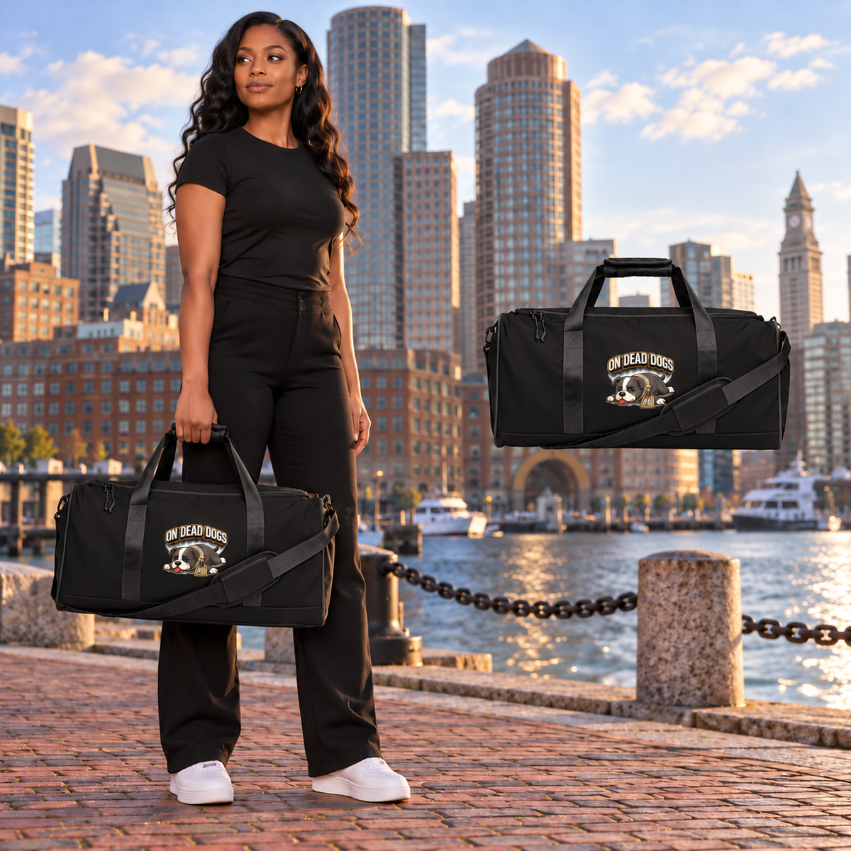 Black adult model with On Dead Dogs duffle in Boston, with matching floating accessory.
