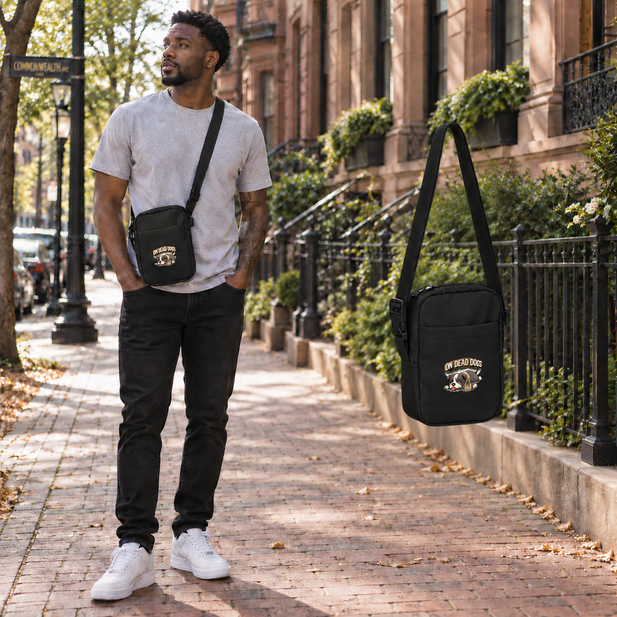 Black adult model wearing On Dead Dogs utility crossbody bag in Boston Back Bay with matching floating bag at right.