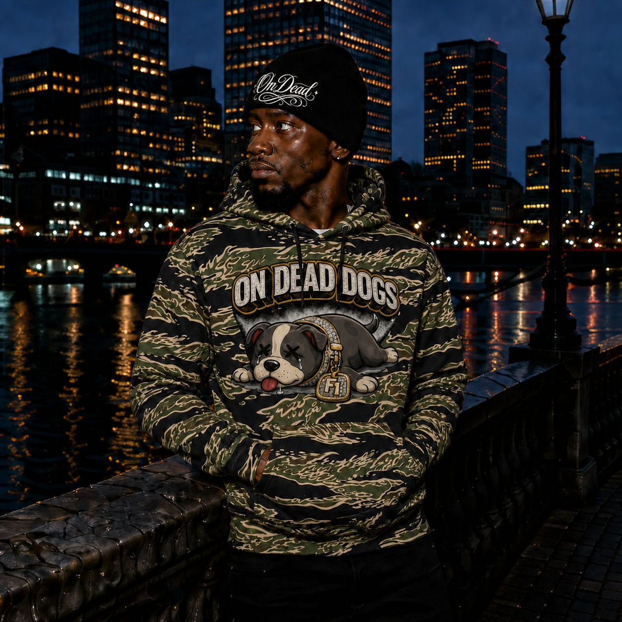 Model wearing the tiger camouflage On Dead Dogs hoodie and black OnDead script beanie in Boston