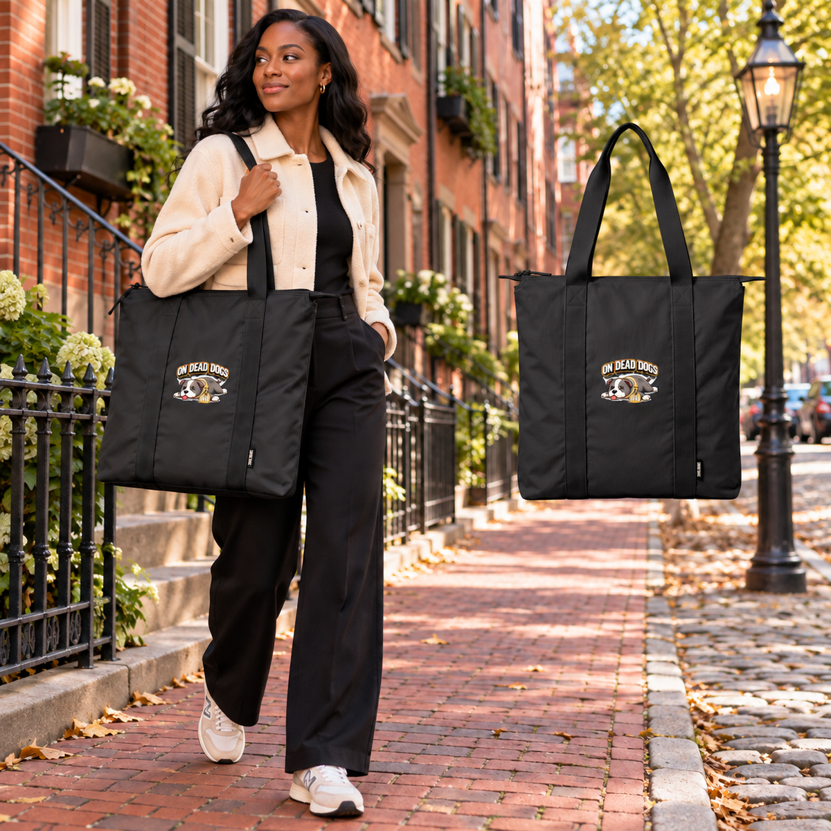 Black adult woman in Boston carrying the On Dead Dogs black zippered carry-all tote with matching floating front view