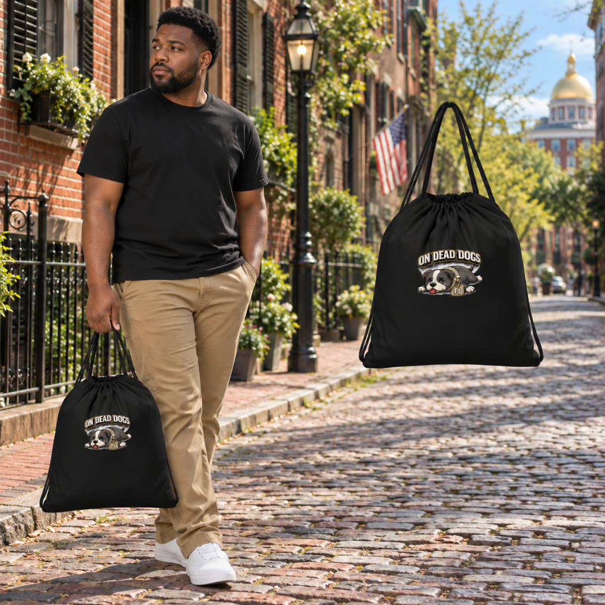 Black adult model holding the On Dead Dogs drawstring bag in Boston with a matching floating bag at right.