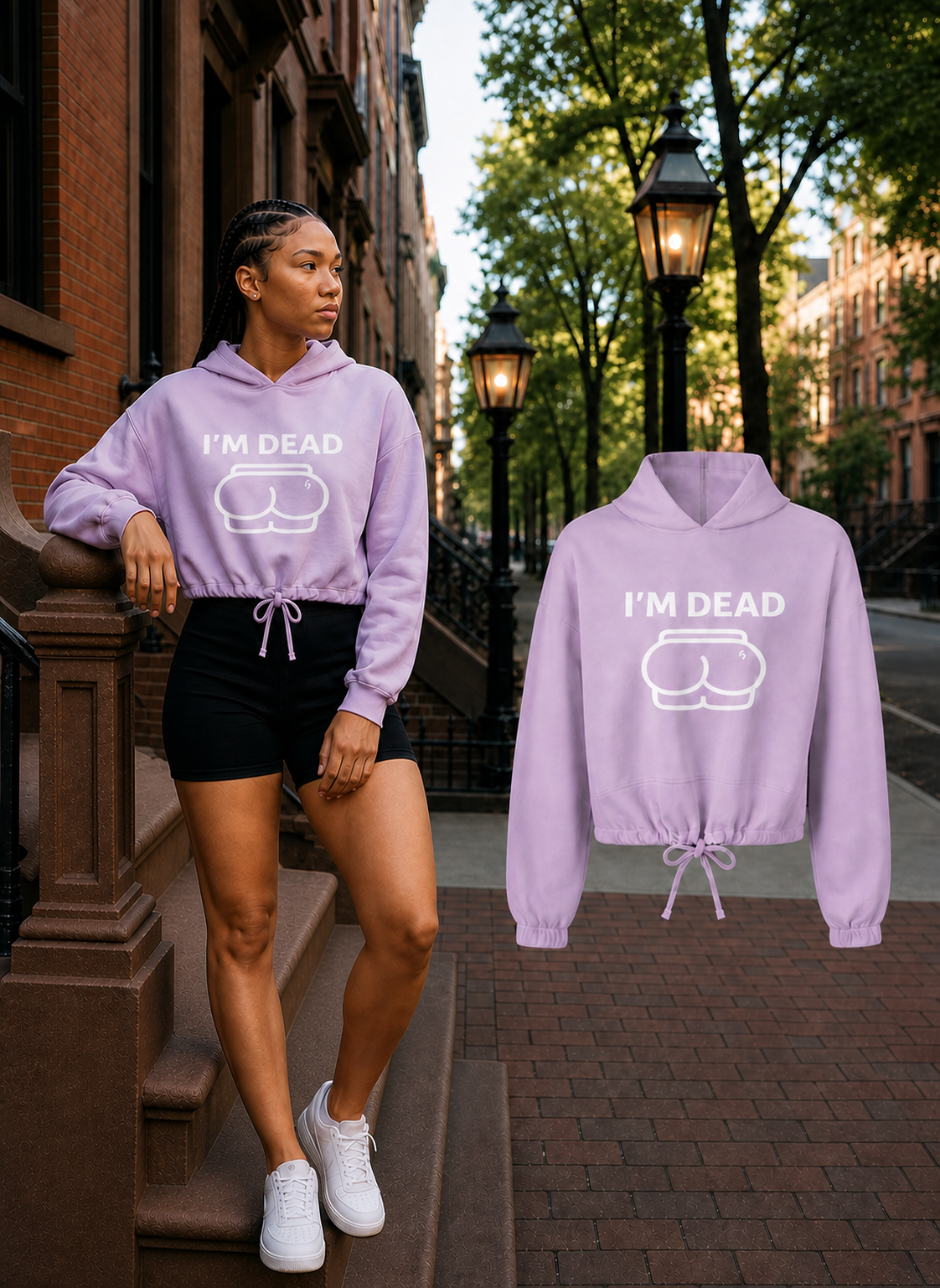 Female model wearing the Lilac Im Dead cropped hoodie beside the matching full-size floating garment on a Boston brownstone street