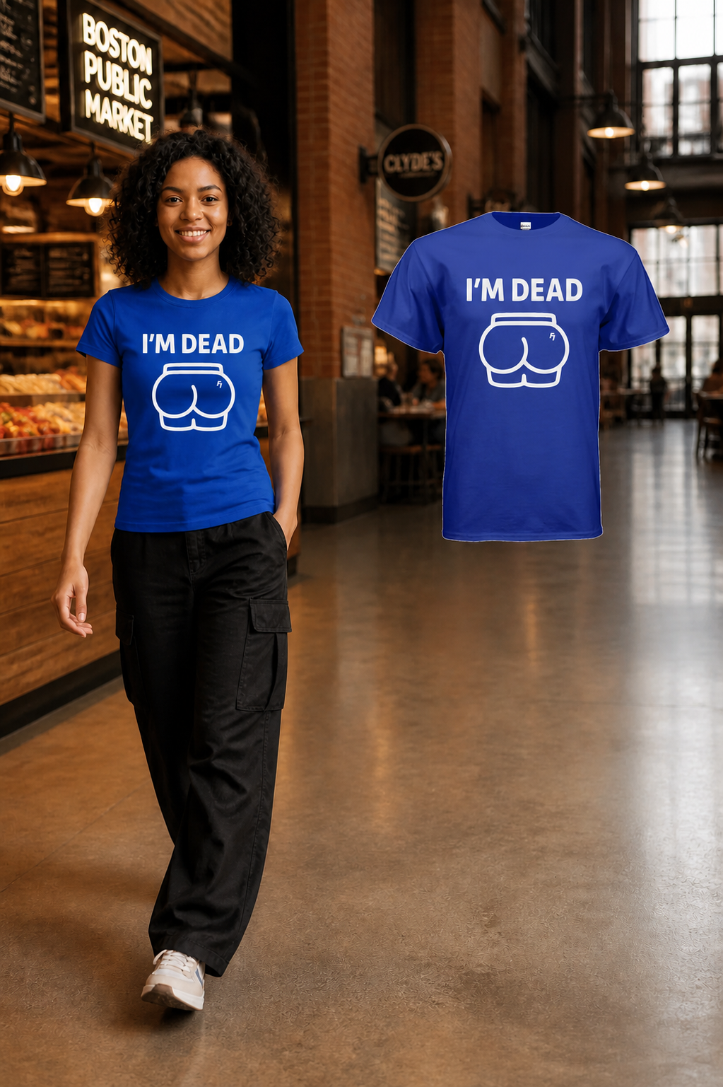 Female model walking through Boston Public Market in the Royal Im Dead T-shirt beside the matching shoulder-level floating garment