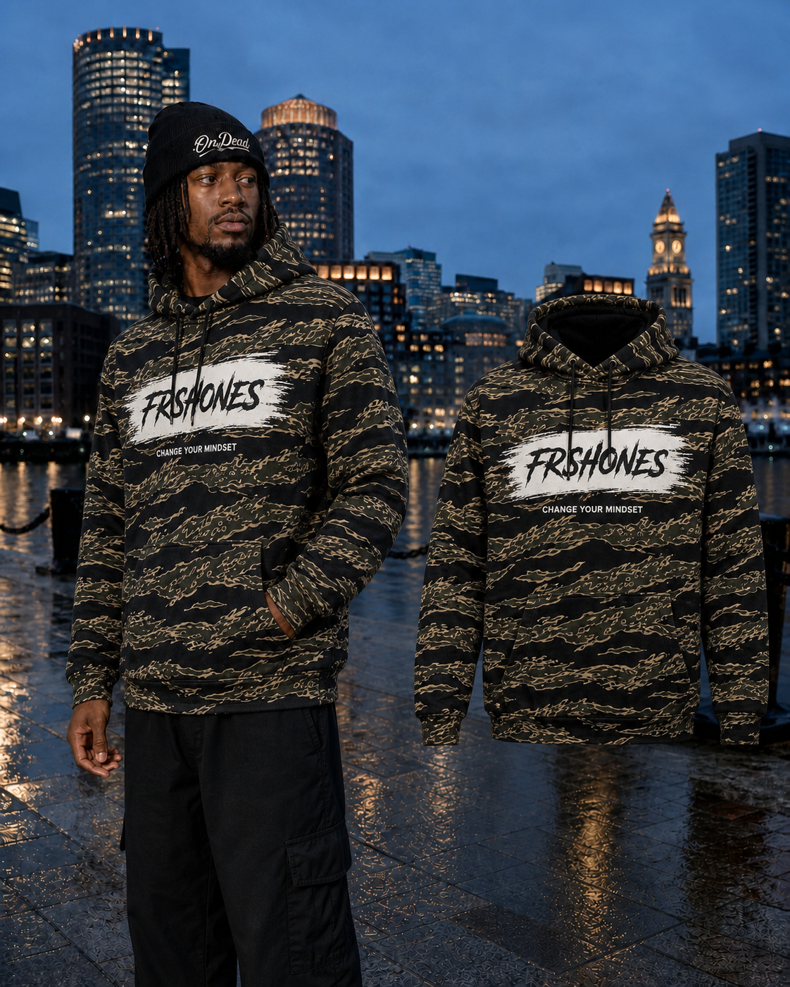 Different model wearing the Tiger Camo Premium Stroke of Genius hoodie beside the matching floating garment in Boston